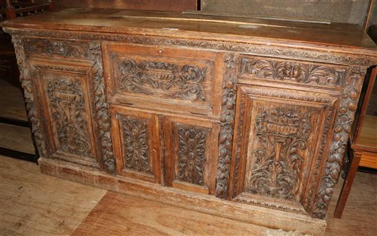 A Victorian heavily carved oak sideboard